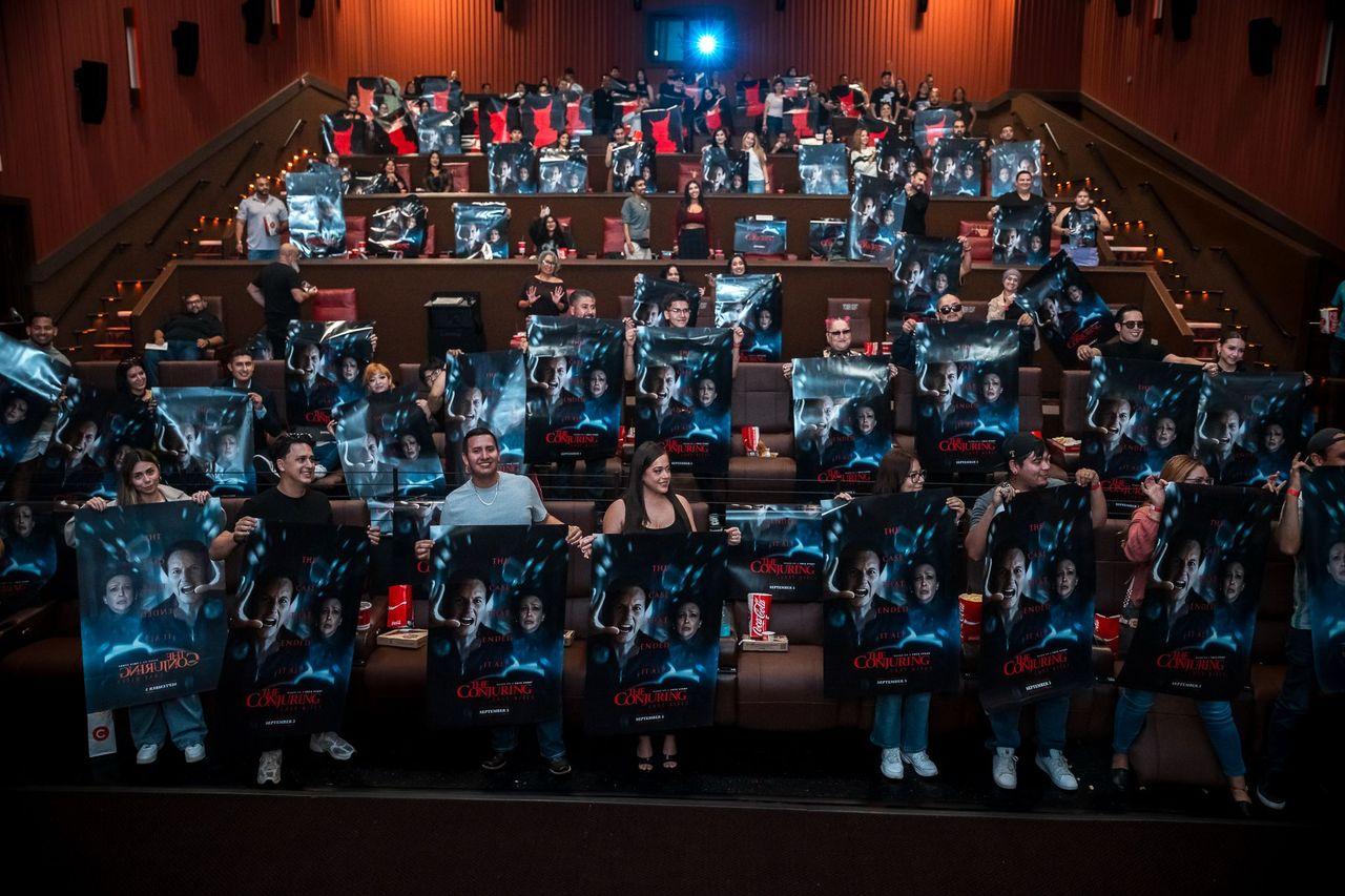 The Conjuring premiere — sold-out theater audience holding posters